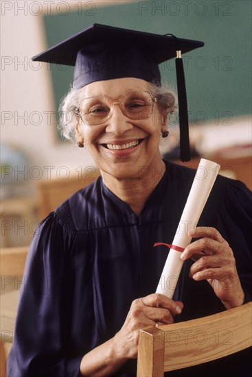 Senior student wearing graduation gown. Photo : Rob Lewine