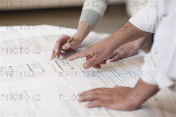 Hands pointing to a engineer's drawing. Photo : Dan Bannister