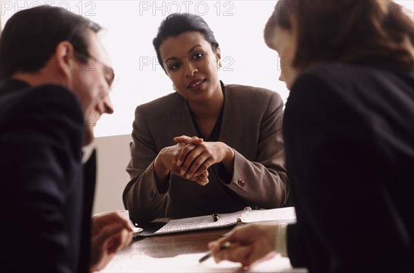 Financial advisor talking to couple. Photo : Rob Lewine