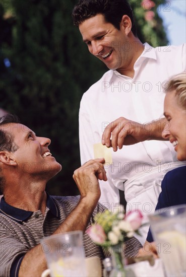 Man giving his credit card to waiter. Photo : Rob Lewine