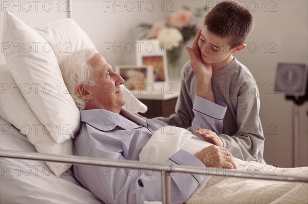 Grandson visiting Grandfather in hospital. Photo : Rob Lewine