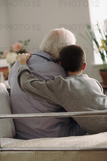 Grandson visiting Grandfather in hospital. Photo : Rob Lewine