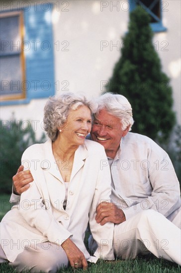 Senior couple relaxing on lawn together. Photo : Rob Lewine