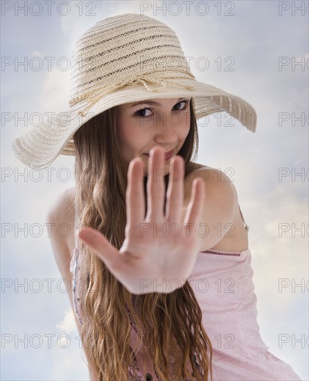 Woman holding her hand out in front of her. Photo : Mike Kemp