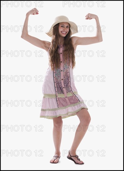 Beautiful long haired woman flexing her muscles. Photo : Mike Kemp