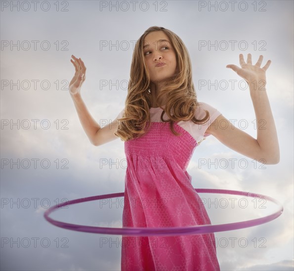 Teenage girl playing with a hula hoop. Photo : Mike Kemp