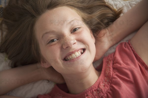 Young girl making cheesy smile. Photo : Mike Kemp