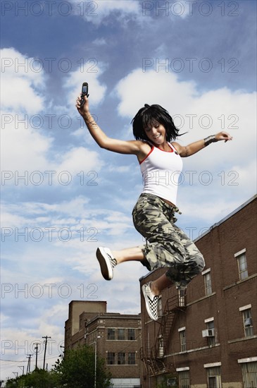 Teenage girl jumping in the air. Photo : Stewart Cohen