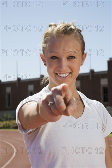 Teenage girl pointing her finger. Photo : Stewart Cohen