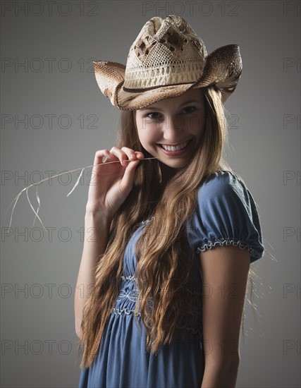 Beautiful long haired cowgirl chewing on grass. Photo : Mike Kemp