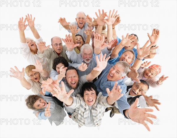 A group of people waving with their arms raised. Photo : momentimages