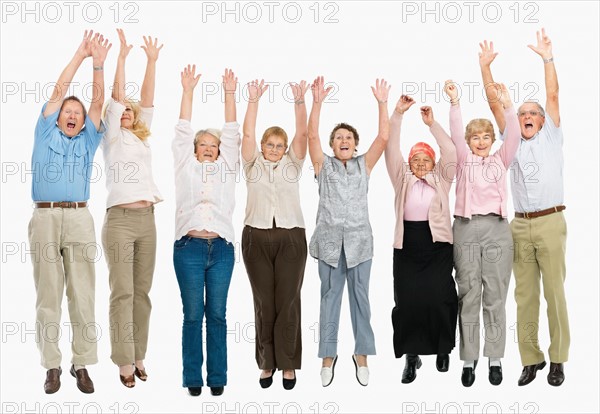 A group of people jumping with their arms raised. Photo : momentimages