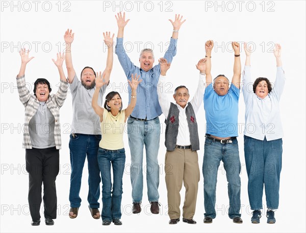 A group of people jumping with their arms raised. Photo : momentimages