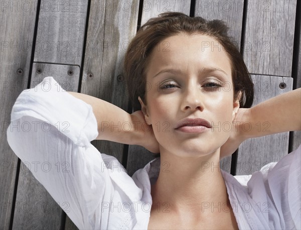 Pretty woman relaxing on porch. Photo : momentimages