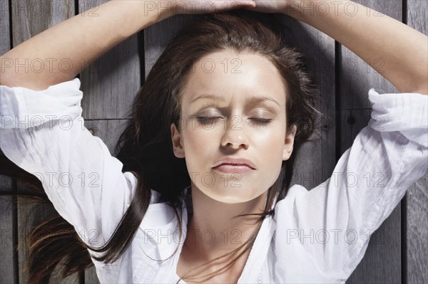 Pretty woman sleeping on porch. Photo : momentimages