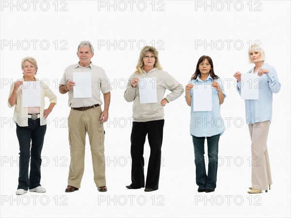 Group of people standing in a row holding papers. Photo : momentimages