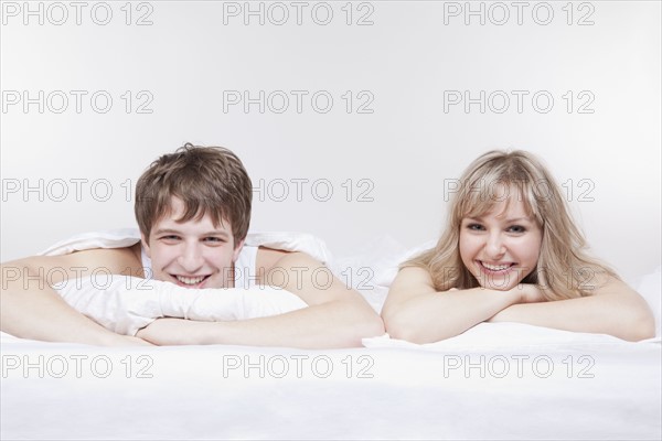 Couple lying in bed together. Photo : Take A Pix Media