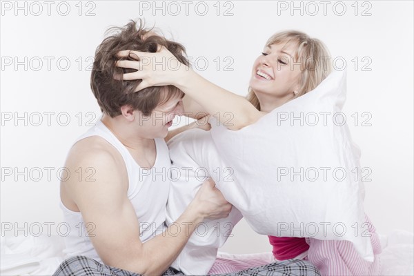 Couple having a pillow fight. Photo : Take A Pix Media