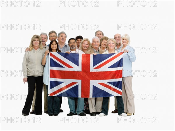 Group of people holding the British flag. Photo : momentimages