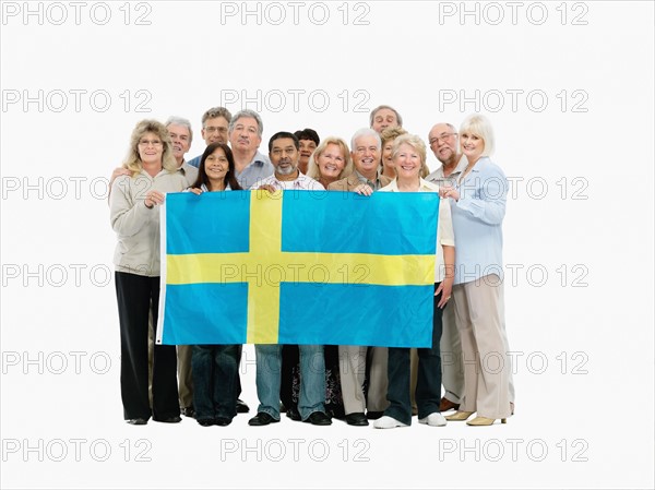 Group of people holding the Swedish flag. Photo : momentimages