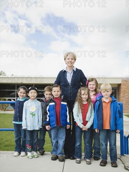 Elementary school students and teacher on a field trip.