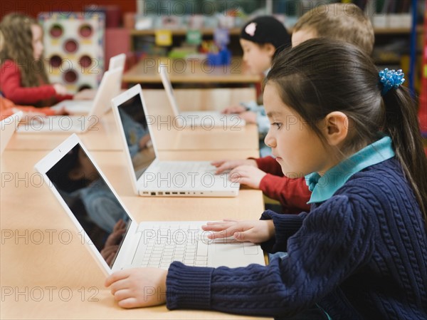 Kindergarten students working on laptops.