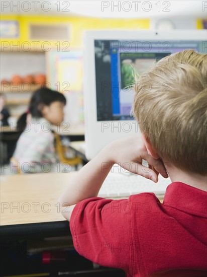 Elementary students working on computers.