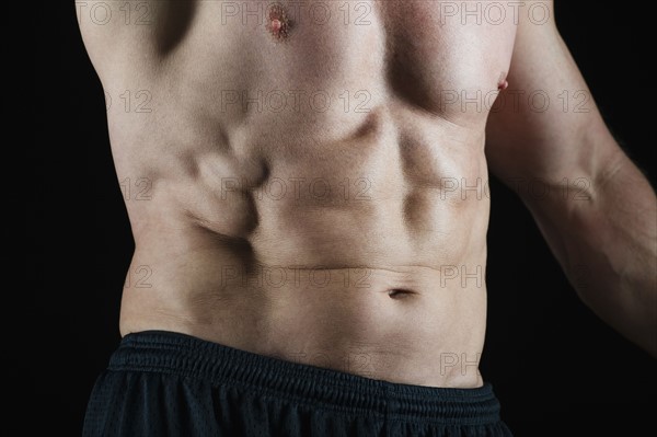 Abs of muscular man. Photo : Daniel Grill