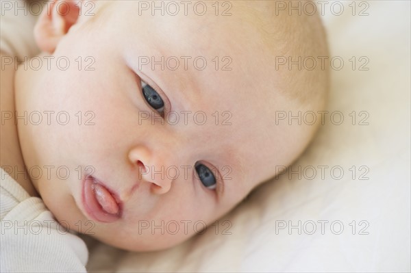 Infant sticking his tongue out. Photo : Chris Grill