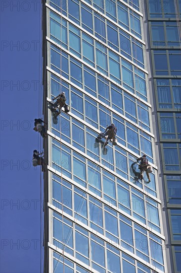 Window washers cleaning windows on skyscraper. Photo : fotog