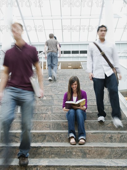 College students on steps in front of library.