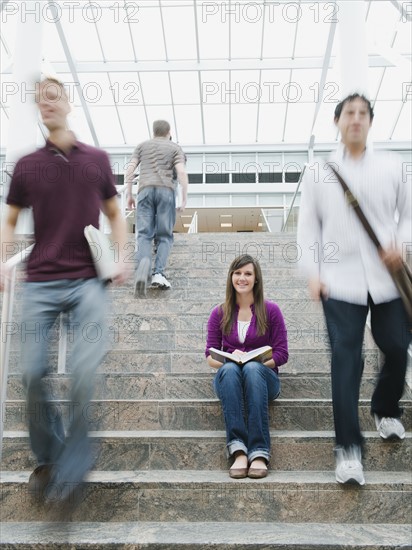 College students on steps in front of library.