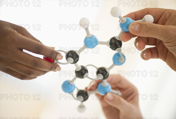 Hands holding genetic molecules.