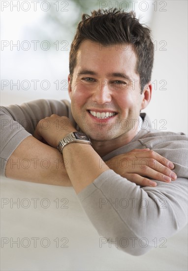 Handsome man relaxing on couch.