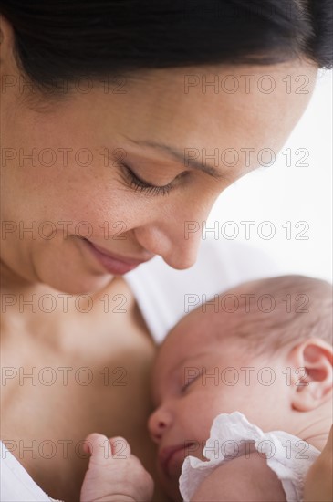 Mother holding her sleeping baby.