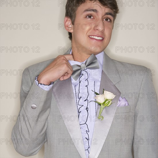 Man wearing grey tuxedo.