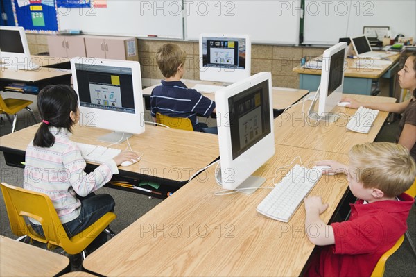 Children working at computers in classroom.