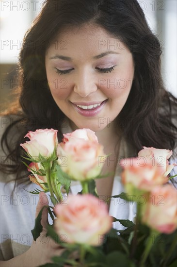 Woman holding a bouquet of roses.