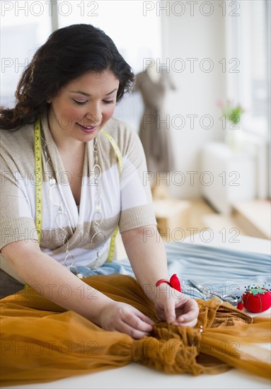 Tailor mending a dress.