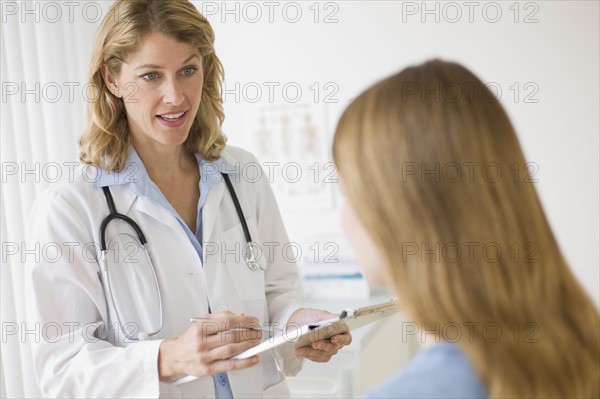 Doctor talking to patient in exam room.