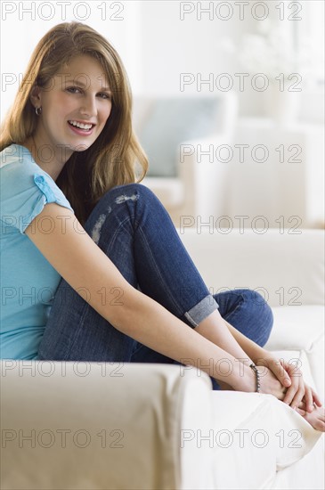 Young woman relaxing on couch.