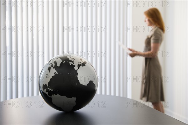 Globe on conference room table.