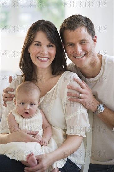 Portrait of parents and their baby daughter.