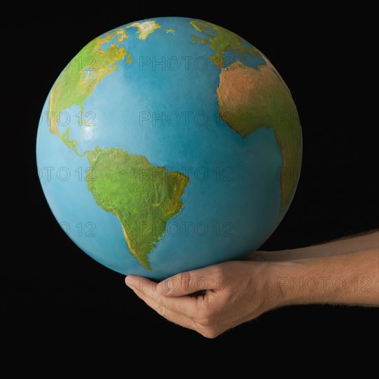 Hands holding globe. Photo. Mike Kemp