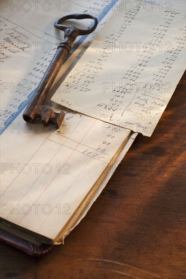 Antique key on top of ledger.