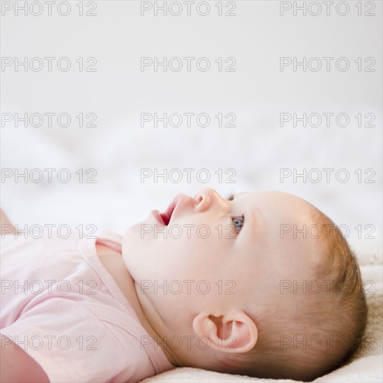 Baby lying on back. Photo. Jamie Grill