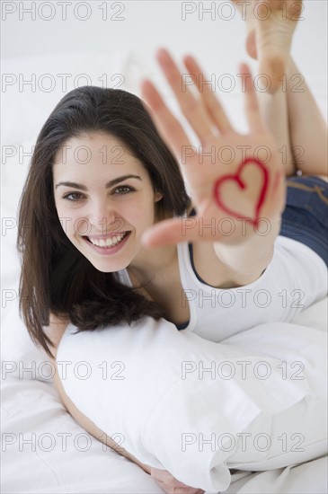 Woman with a heart drawn on her hand. Photo : Jamie Grill