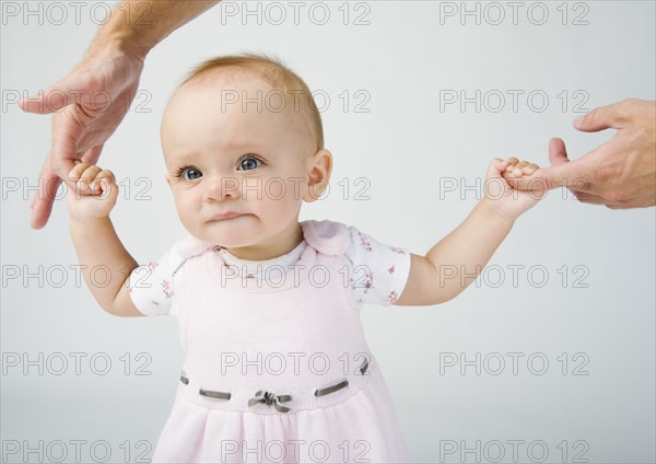 Baby holding father`s fingers.