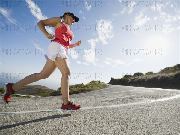 Woman running on a road in Malibu.