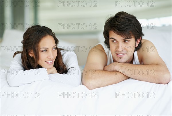 Happy couple relaxing on bed. Photo. momentimages